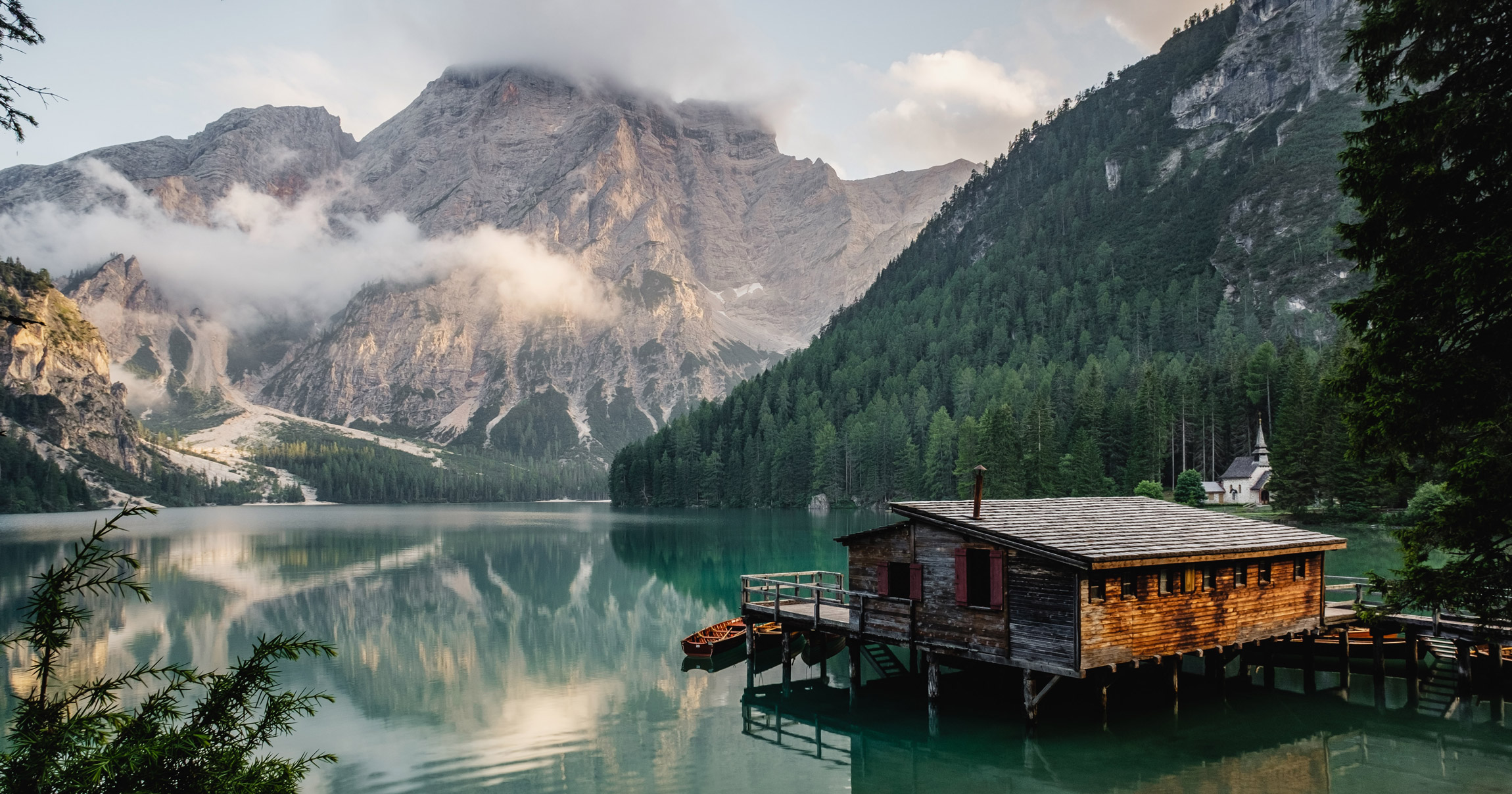 A lakeside cabin below alpine forest, a Hermes Group destination